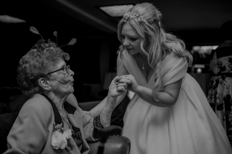 Bride and grandmother caring an emotional moment at a wedding.