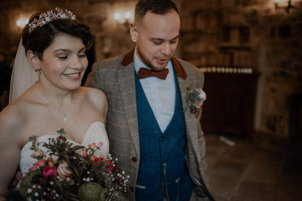 Bride and groom smiling as they exit their wedding ceremony at Barn wedding. 