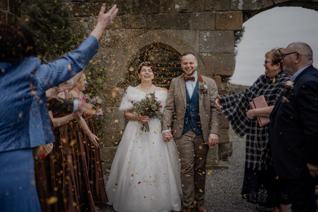 Confetti shot outside Danby Castle Barn during Romantic Winter Wedding