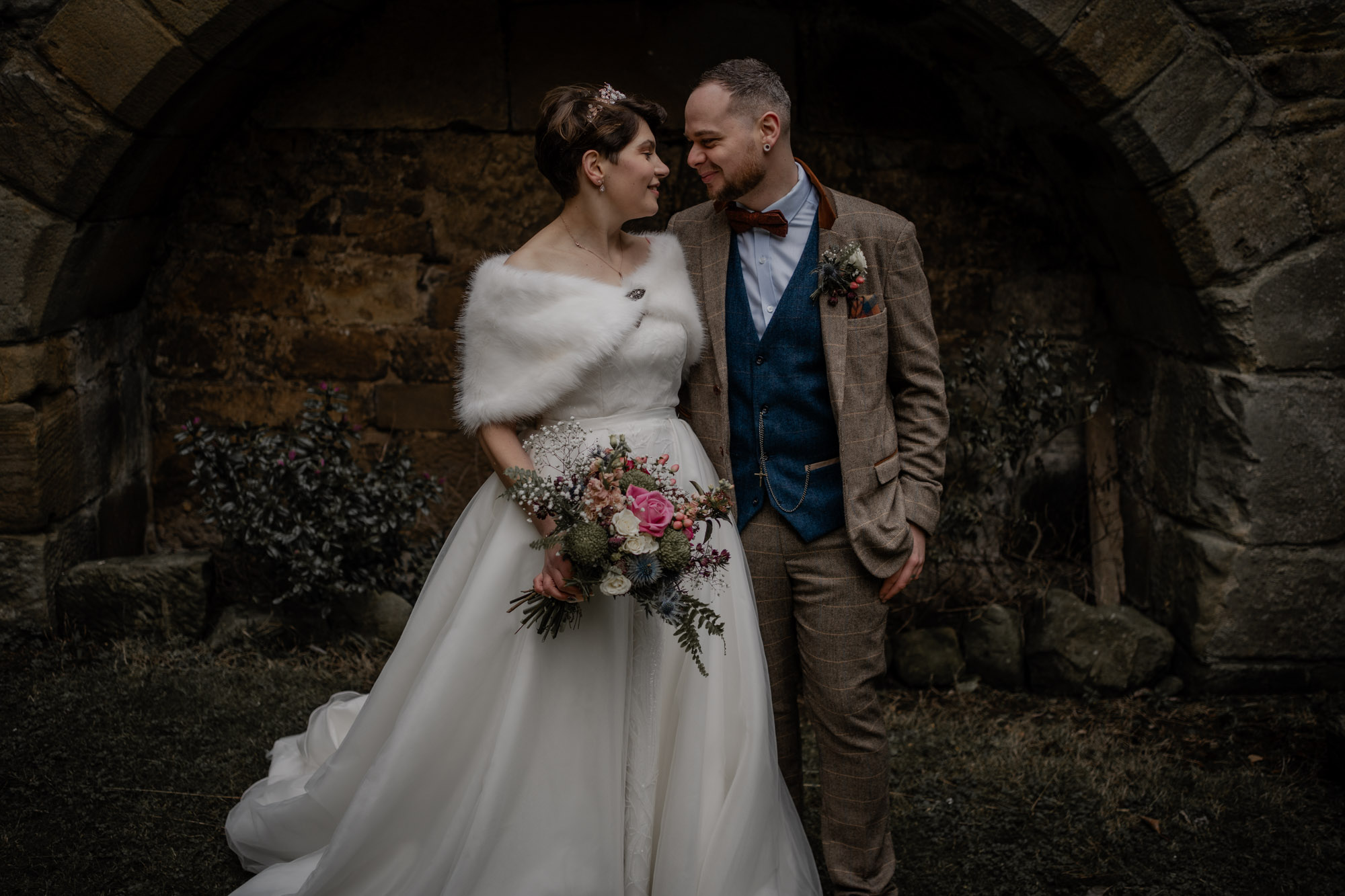 Bride and Groom during couple portrait in winter wedding in Danby Castle Barn Wedding venue.